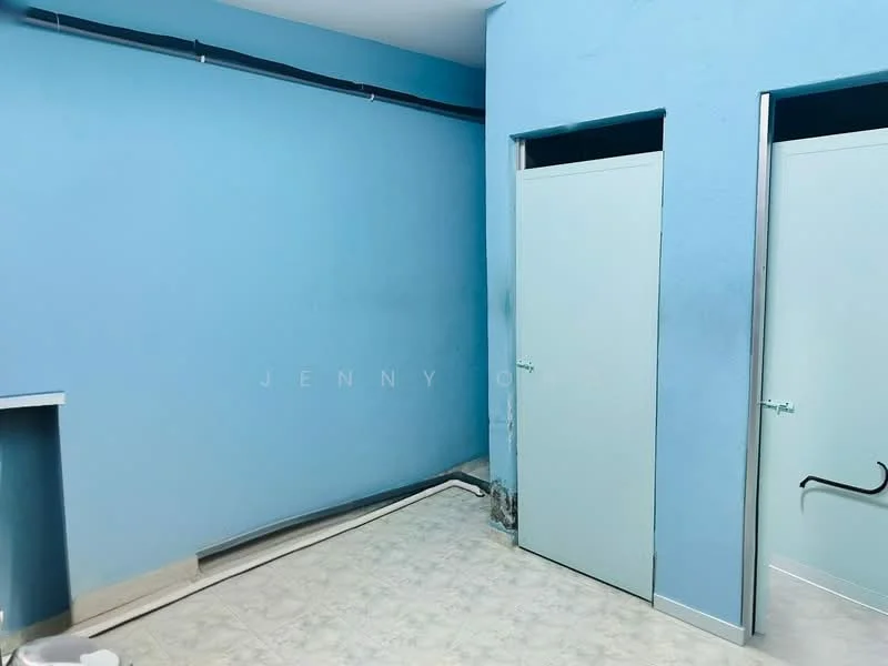 Room features: blue painted walls, light-colored tile flooring, two doors, corner shelf, baseboard, no visible windows, minimal decor.