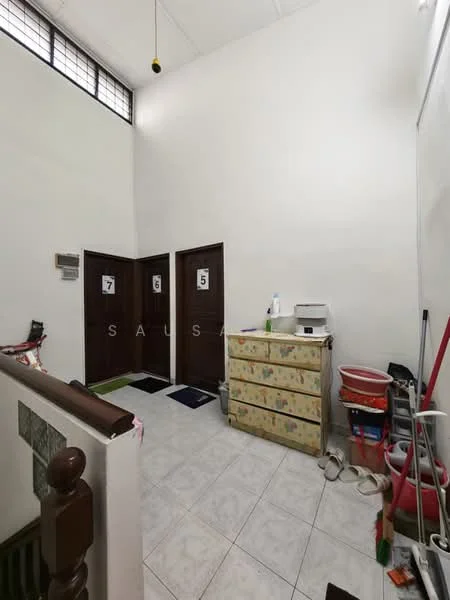 Room features: white painted walls, high ceiling, tile flooring, wooden doors, numbered door signs, decorative dresser with floral pattern, cleaning supplies, mop and bucket, shoe mats; style: modern.