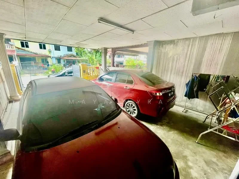 Exterior type: car porch; features: covered car porch, two parked cars, concrete flooring, metal railing, exposed ceiling, surrounding greenery, residential street view; style: modern.