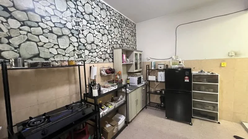 Kitchen features: stone accent wall, cream tiled walls, laminate countertop, black gas stove with two burners, black refrigerator, white microwave, glass-front cabinets, open shelving, various kitchen utensils, plastic storage containers, tile flooring; style: modern.