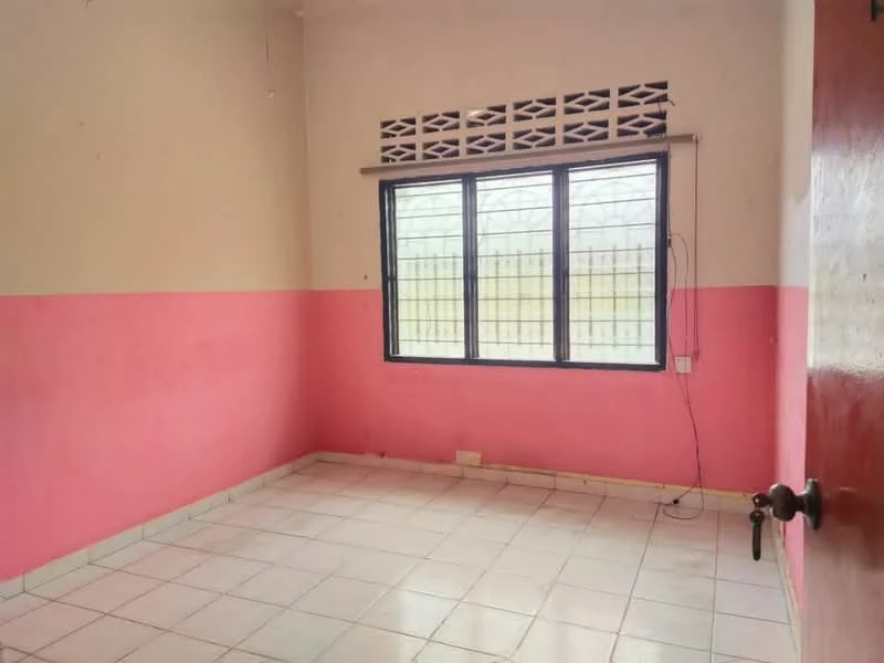Room features: pink painted walls, white tiled flooring, window with security bars, single door, ceiling light fixture.