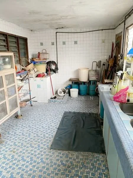 Laundry features: blue mosaic tile flooring, white tiled walls, glass-front cabinet, metal shelving unit, various cleaning supplies, plastic storage bins, laundry basket, sink with countertop, black rubber mat.