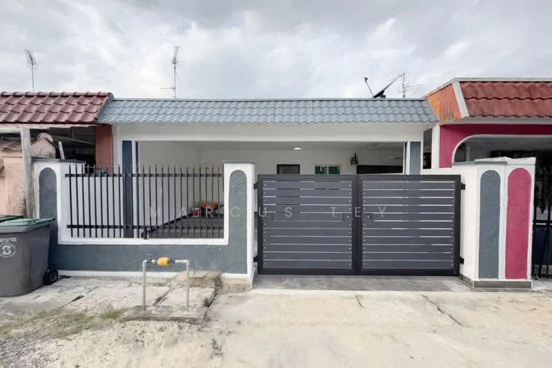 Exterior type: linked terrace house; features: grey painted facade, red accent wall, flat roof, metal gate, fence with vertical bars, paved driveway, manicured lawn, two-tone exterior, visible antennae on roof; style: modern.