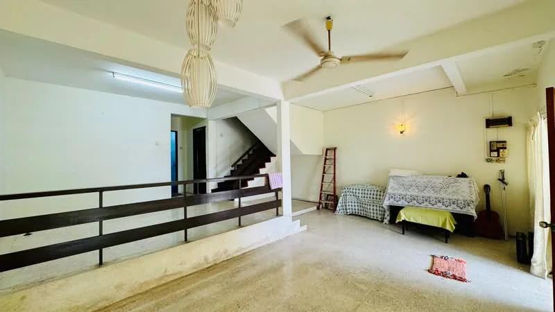 Room features: ceiling fan, white painted walls, marble flooring, staircase with wooden railing, bed with white bedding, green bed cover, wooden ladder, light fixture on wall, window with blue frame, area rug, open space layout; style: minimalist.