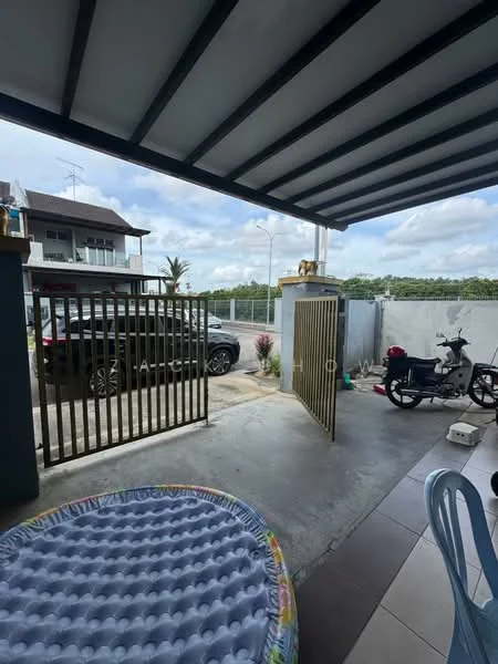Exterior type: linked terrace house; features: metal gate, concrete driveway, paved walkway, car parked in driveway, motorbike parked, outdoor seating area, landscaped garden, roof overhang, fence surrounding property, open sky, surrounding greenery; style: modern.
