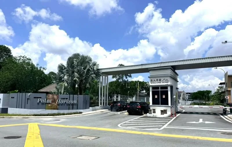 Exterior type: gated community; features: main entrance gate with security booth, paved driveway, landscaped greenery, palm trees, signage with 'Palm Horizon', guard house at entrance, surrounded by residential buildings, clear blue sky, white clouds; style: modern.