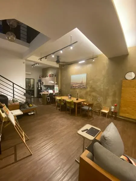 Living features: exposed concrete wall, wooden flooring, recessed downlights, track lighting, dining table with chairs, sofa, wall clock, open shelving, artwork on wall, kitchen area visible in background, staircase, large windows, decorative items on shelves; style: industrial.