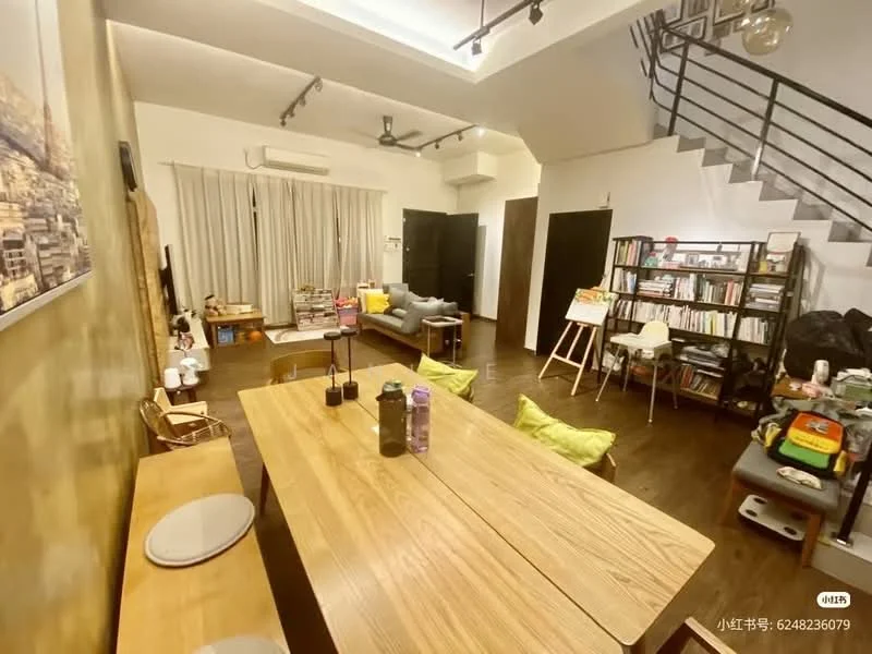Living features: wooden flooring, white painted walls, recessed downlights, 5-blade ceiling fan, floor-to-ceiling windows with sheer curtains, L-shape sectional sofa in grey, wooden dining table, upholstered dining chairs, bookshelf with books and decorative items, art easel, decorative wall art, open shelving, air conditioning unit; style: modern.