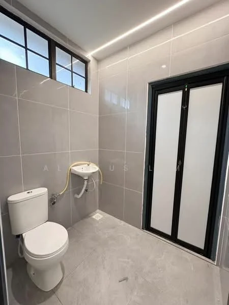 Bathroom features: grey ceramic tile flooring, grey tiled walls, white one-piece toilet, wall-mounted sink, black framed sliding door, window with grid design, LED strip lighting, shower area with drainage, toilet paper holder; style: modern.