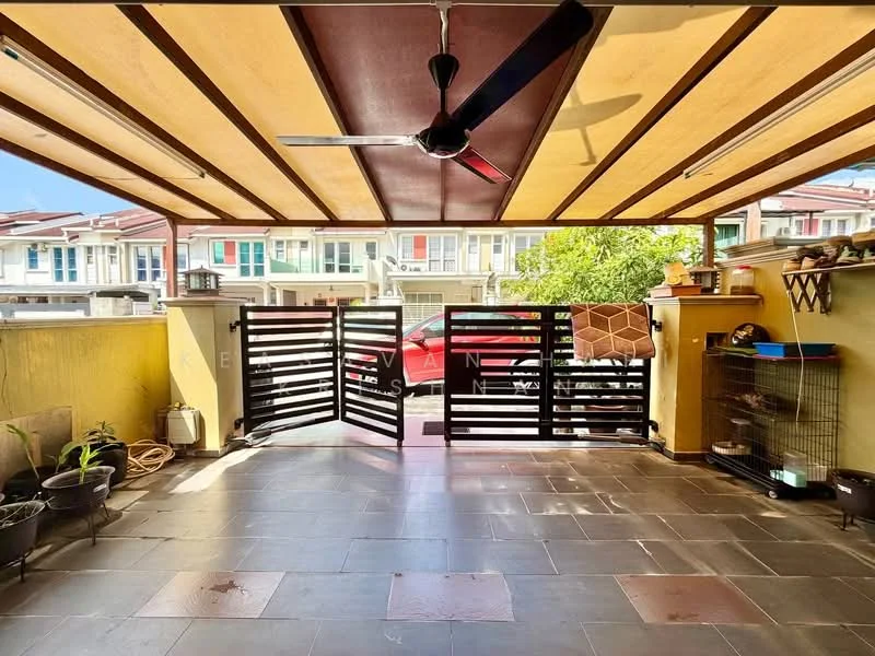 Exterior type: linked terrace house; features: sliding gate, covered porch with awning, stone-paved flooring, manicured plants in pots, fenced area, visible parking space, surrounded by residential houses, natural light from clear sky; style: modern.
