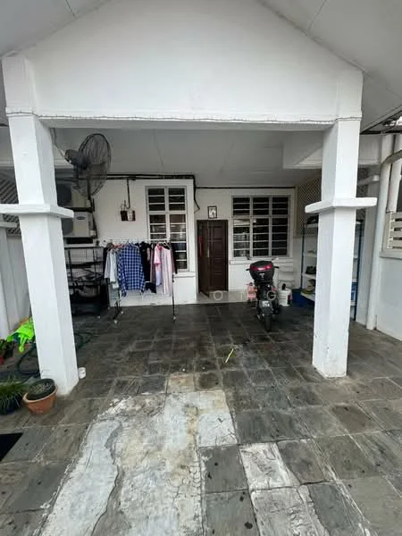 Exterior type: linked terrace house; features: white painted facade, flat roof, stone-paved walkway, covered porch area, outdoor ceiling fan, motorcycle parked, clothes hanging on rack, potted plant, windows with grilles; style: traditional.