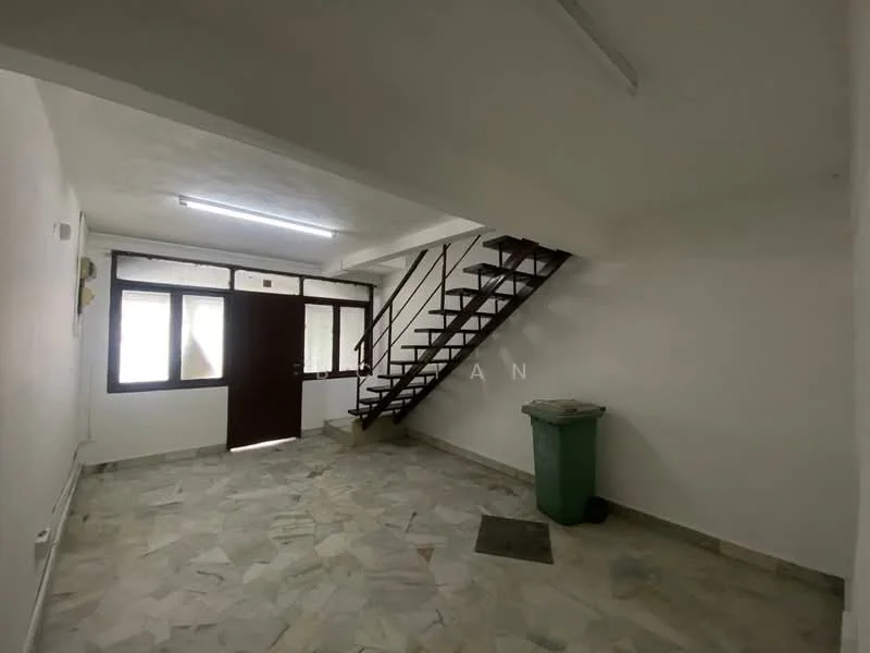 Room features: white painted walls, marble flooring, staircase with metal railing, large windows, main entrance door, green trash bin, ceiling lights, corner floor mat.