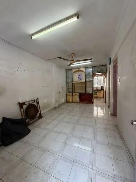 Room features: white painted walls, ceiling with fluorescent lights, wall-mounted ceiling fan, tiled flooring, glass display cabinet, wooden shelving unit, red upholstered seating, open space layout.