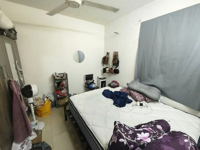 Bedroom features: queen-size bed, upholstered headboard, bedding with floral pattern, ceiling fan, wall-mounted mirror, grey curtain, built-in wardrobe, floor tiles, clothing and accessories on hooks, small shelving unit, miscellaneous items on floor.