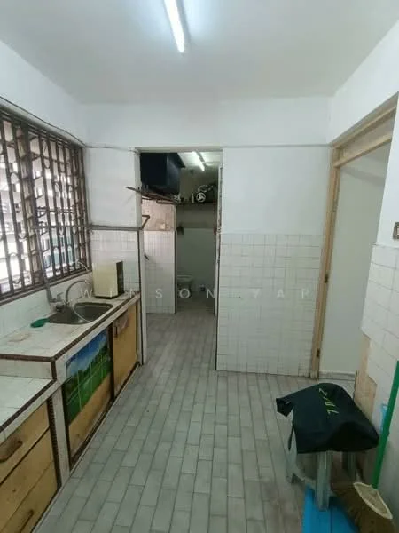 Kitchen features: single-bowl stainless-steel sink, chrome pull-down faucet, wood cabinetry with laminate finish, tile backsplash, white tiled walls, grey tiled flooring, window with metal grille, open shelving, utility area with storage, door leading to utility room.