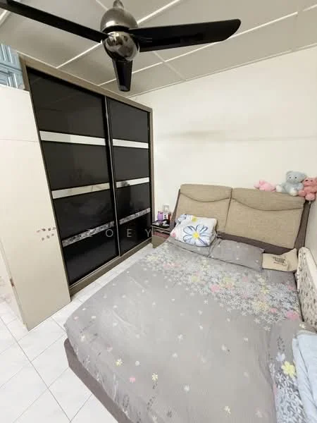 Bedroom features: queen-size bed with floral bedding, upholstered headboard, black sliding wardrobe with glass panels, wall-mounted fan, decorative pillows, stuffed toys on the bed, white tiled flooring, light-colored walls, nightstand with items on it; style: modern.