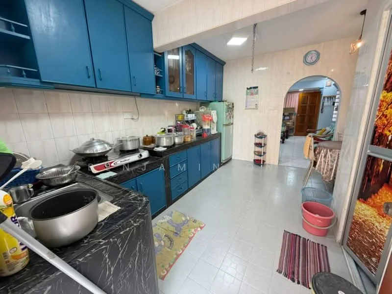 Kitchen features: blue cabinetry, black marble countertop, stainless-steel sink, chrome faucet, ceramic tile flooring, white tiled walls, built-in oven, freestanding gas stove, refrigerator, multiple pots and pans, kitchen rug, open shelving, wall clock.
