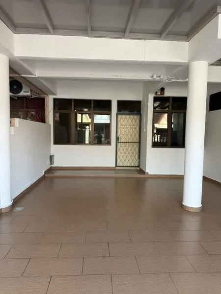 Room features: white painted walls, light brown tiled flooring, exposed ceiling beams, 1 wall-mounted split AC, large windows, metal security door, open layout, column supports; style: modern.
