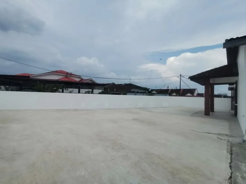 Exterior features: concrete flooring, white painted wall, overhead power lines, surrounding residential buildings, partially cloudy sky.