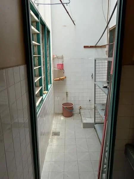 Laundry features: white tiled walls, grey tiled flooring, metal shelving unit, washing basin, laundry bucket, window with metal grilles, hanging clothes line, drainage outlet.