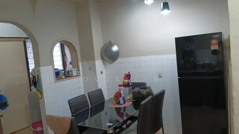 Kitchen features: black refrigerator, glass dining table, 4 grey dining chairs, white tiled walls, hanging light fixtures, sink, kitchen utensils on countertop, window with sheer curtains.