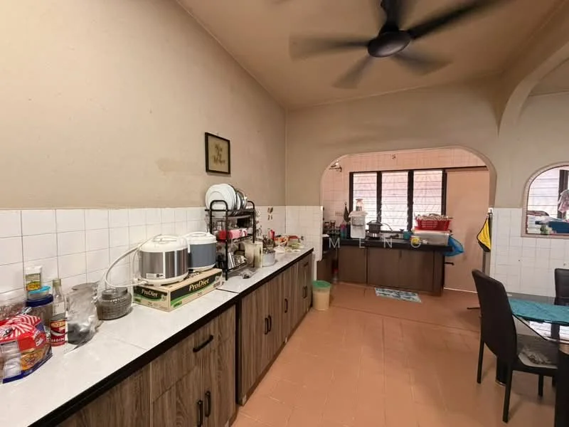 Kitchen features: white tiled backsplash, laminate countertop, wood cabinetry, stainless-steel sink, chrome faucet, kitchen appliances including kettle and coffee machine, dining table with chairs, ceiling fan, tile flooring, window with view to outside.