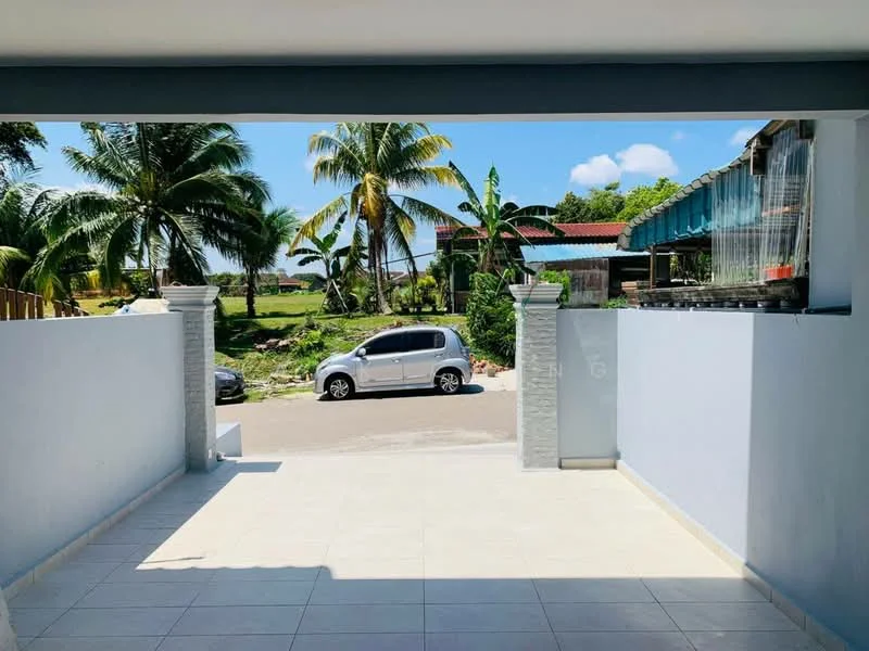 Exterior features: paved driveway, white painted walls, stone-clad pillars, tropical landscaping, palm trees, open view of the street, visible car parked on the street, clear blue sky; style: modern.