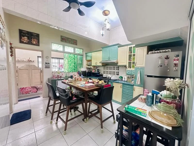 Kitchen features: light green cabinetry, cream cabinetry, stainless-steel fridge, built-in oven, 4-burner gas hob, double-bowl stainless-steel sink, chrome pull-down faucet, white tiled backsplash, white tiled flooring, ceiling fan with light, dining table with chairs, open shelving, window with sheer curtains, decorative plants, kitchen island; style: modern. Room features: white painted walls, doorway leading to another room, decorative items on shelves.