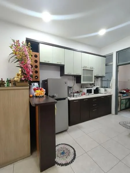 Kitchen features: L-shaped kitchen layout, white upper cabinets, dark wood lower cabinets, stainless-steel fridge, built-in microwave, ceramic tile flooring, countertop with sink, kitchen island with storage, decorative flower arrangement, wall-mounted cabinet with wine rack, kitchen appliances including kettle and toaster, recessed ceiling lights; style: modern.