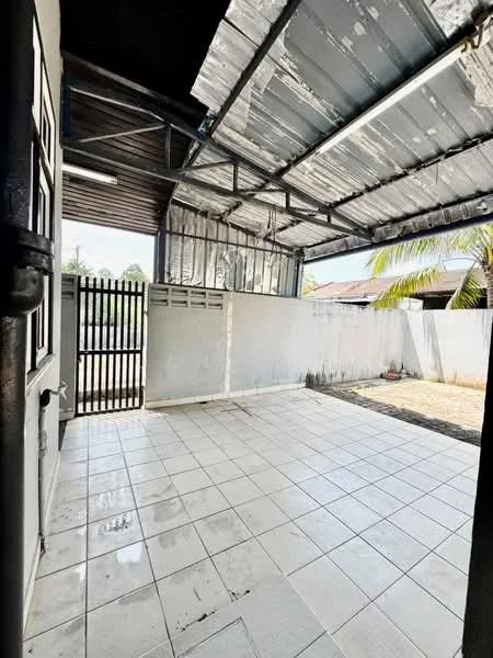 Room features: grey tiled flooring, metal roof, exposed beams, white painted walls, sliding gate, outdoor space, fenced perimeter, natural light from windows; view: garden.