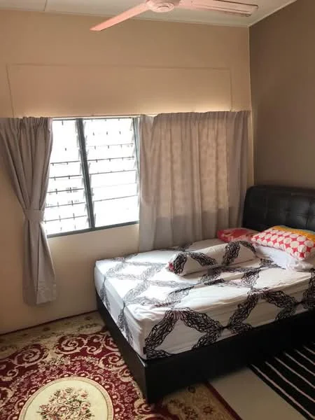 Bedroom features: queen-size bed with black upholstered headboard, white bedding with geometric pattern, decorative pillows in various colors, window with metal grille, grey curtains, cream painted walls, area rug with floral pattern, ceiling fan; style: modern.