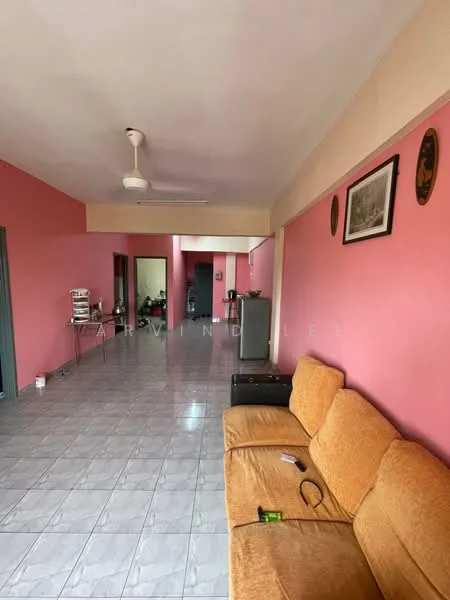 Living features: orange fabric sofa, ceiling fan, pink painted walls, glossy grey tile flooring, framed artwork on wall, open layout, multiple doorways, kitchen area visible in background.