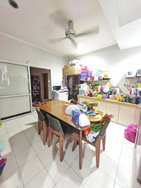 Dining features: rectangular wooden dining table, 6 wooden dining chairs, ceiling fan, white walls, tile flooring, built-in cabinets, various kitchen appliances, colorful plastic containers, shelves with assorted items, open doorway to adjacent room, bright overhead lighting.