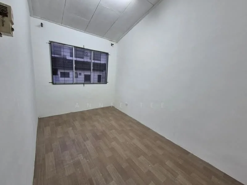 Room features: white painted walls, vinyl plank flooring, window with black metal grille, 1 wall-mounted split AC, ceiling with panels.