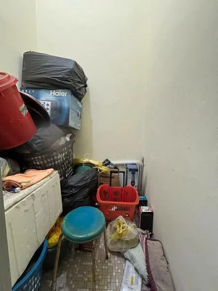 Room features: piled plastic storage bins, stacked garbage bags, blue stool, various colored baskets, tiled flooring, light-colored painted walls.