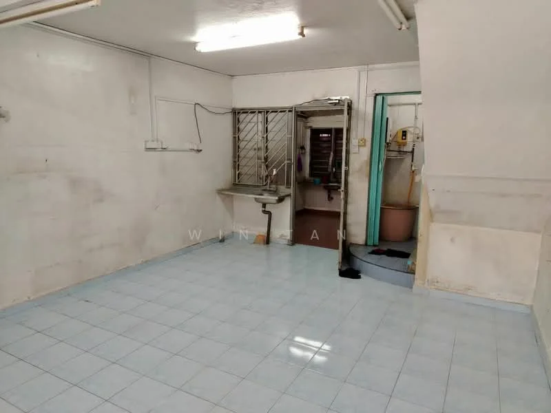Room features: white painted walls, blue ceramic tile flooring, single-bowl stainless-steel sink, metal grilles on window, exposed plumbing, light fixtures on ceiling, doorway leading to another room, staircase leading to another level.