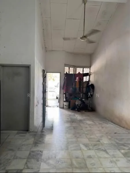 Room features: white painted walls, marble flooring, ceiling fan, doorway leading outside, window with security bars, clothes hanging on rack, open space layout.