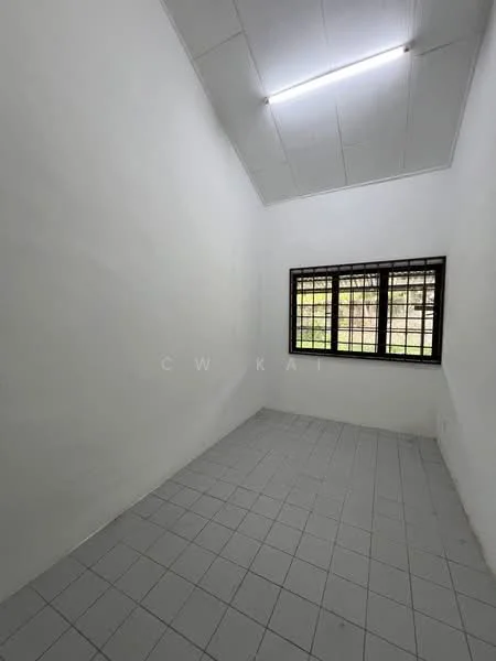 Room features: white painted walls, sloped ceiling, tile flooring, single window with black grille, natural light from window.