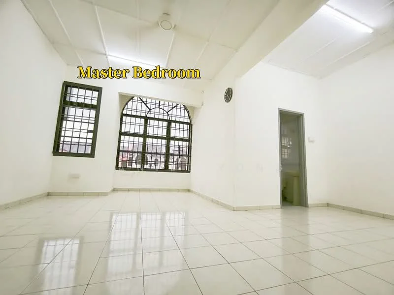Bedroom features: white painted walls, tile flooring, large windows with grid pattern, ceiling light fixture, neutral color scheme, corner room, no visible furniture, spacious layout.