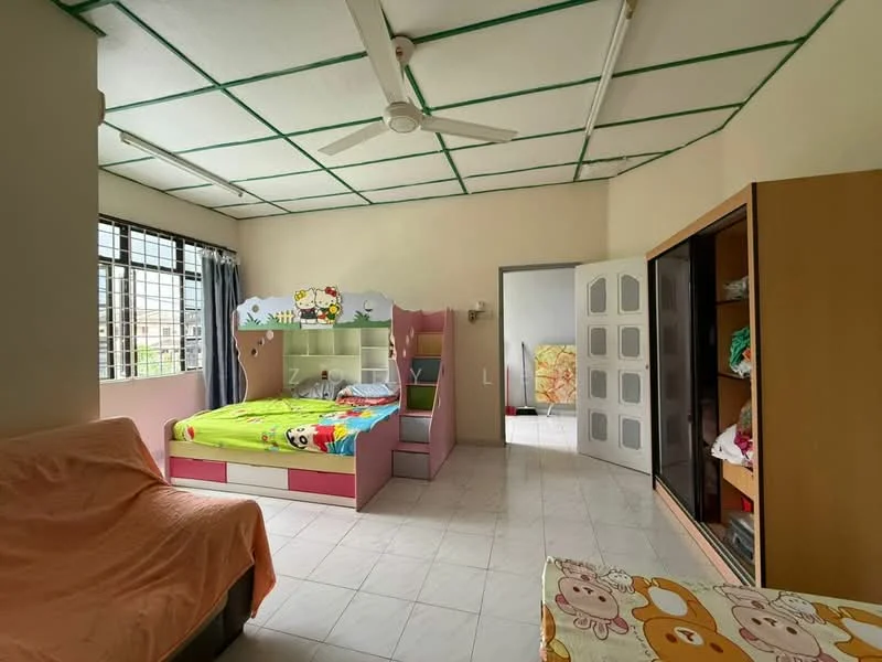Bedroom features: single bed with colorful bedding, built-in wardrobe with sliding doors, sofa with orange cover, ceiling fan, white tiled flooring, large window with sheer curtains, decorative wall with cartoon character design, wall-mounted light fixture.