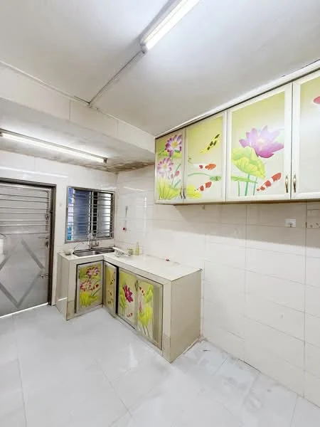 Kitchen features: white tiled walls, light grey tiled flooring, kitchen cabinets with floral design, single-bowl stainless-steel sink, chrome faucet, window with metal grill, overhead fluorescent lighting.