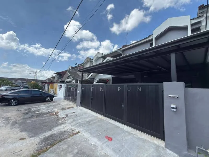 Exterior type: linked terrace house; features: black painted gate, concrete driveway, single-storey, flat roof, grey exterior walls, manicured lawn, surrounded by residential area, paved walkway, car parked in driveway, overhead power lines; style: modern.