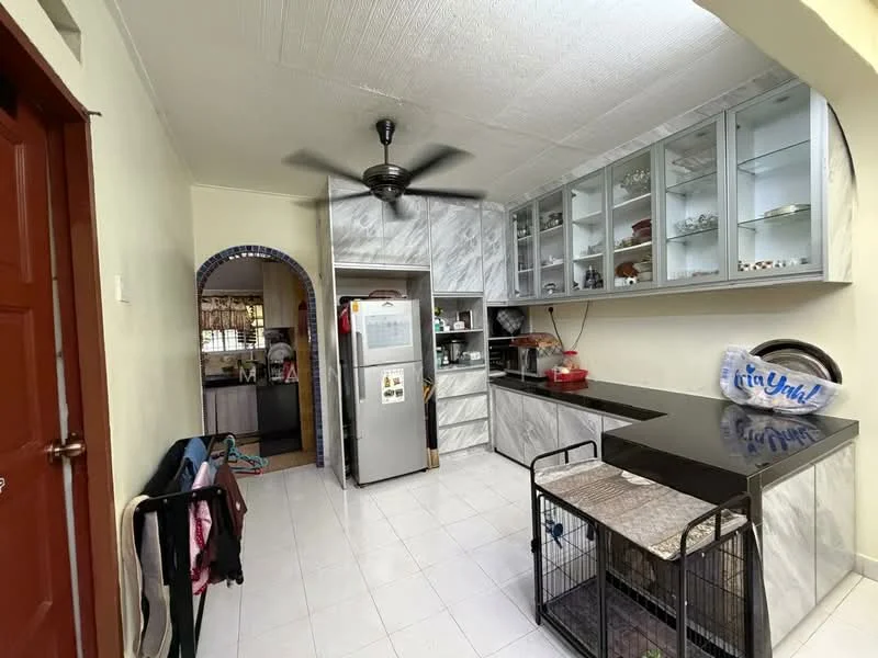 Kitchen features: white tiled flooring, grey marble countertop, stainless-steel fridge, built-in cabinets with glass doors, 5-blade ceiling fan, open shelving, kitchen island with seating, arched entryway, decorative items on shelves; style: modern.