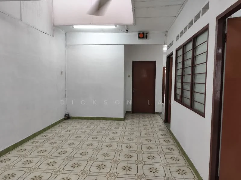 Room features: white painted walls, vinyl tile flooring with floral pattern, ceiling with fluorescent lighting, wooden door with brown finish, window with grid pattern, green baseboard, light switch, air conditioning unit; style: traditional.