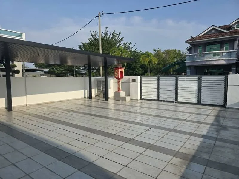 Exterior features: paved flooring with grey and white tiles, covered area with metal roof, white perimeter wall, landscaped greenery in background, fenced area with sliding gates, outdoor space with no visible furniture or amenities; style: modern.