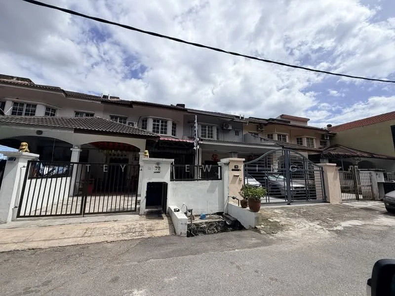 Exterior type: linked terrace house; features: white painted facade, gated entrance, metal gate, paved driveway, front porch with decorative elements, multiple storeys, visible air conditioning units, surrounded by residential buildings, manicured landscaping, street view, cloudy sky; style: modern.