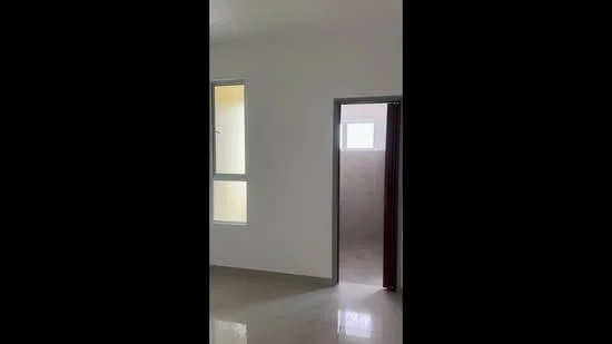 Room features: white painted walls, glossy tile flooring, window with clear glass, doorway leading to another room, neutral color scheme, natural light from window.