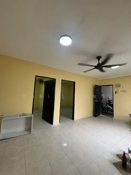 Room features: yellow painted walls, tile flooring, ceiling light fixture, 5-blade ceiling fan, two black doors, one white door, window with no visible treatment, kitchenette area with sink, visible motorcycle outside through door.