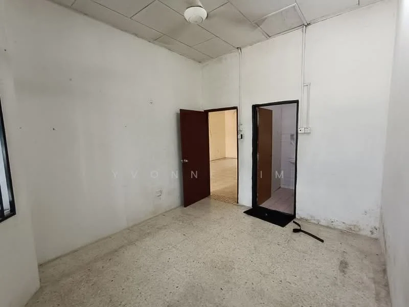 Room features: white painted walls, concrete flooring, single ceiling light fixture, two doors, one window, bare walls, no visible furniture; style: minimalist.