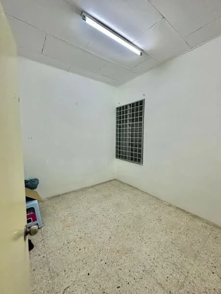 Room features: white painted walls, concrete flooring, fluorescent ceiling light, window with metal grille, no visible furniture, minimal decor; style: minimalist.